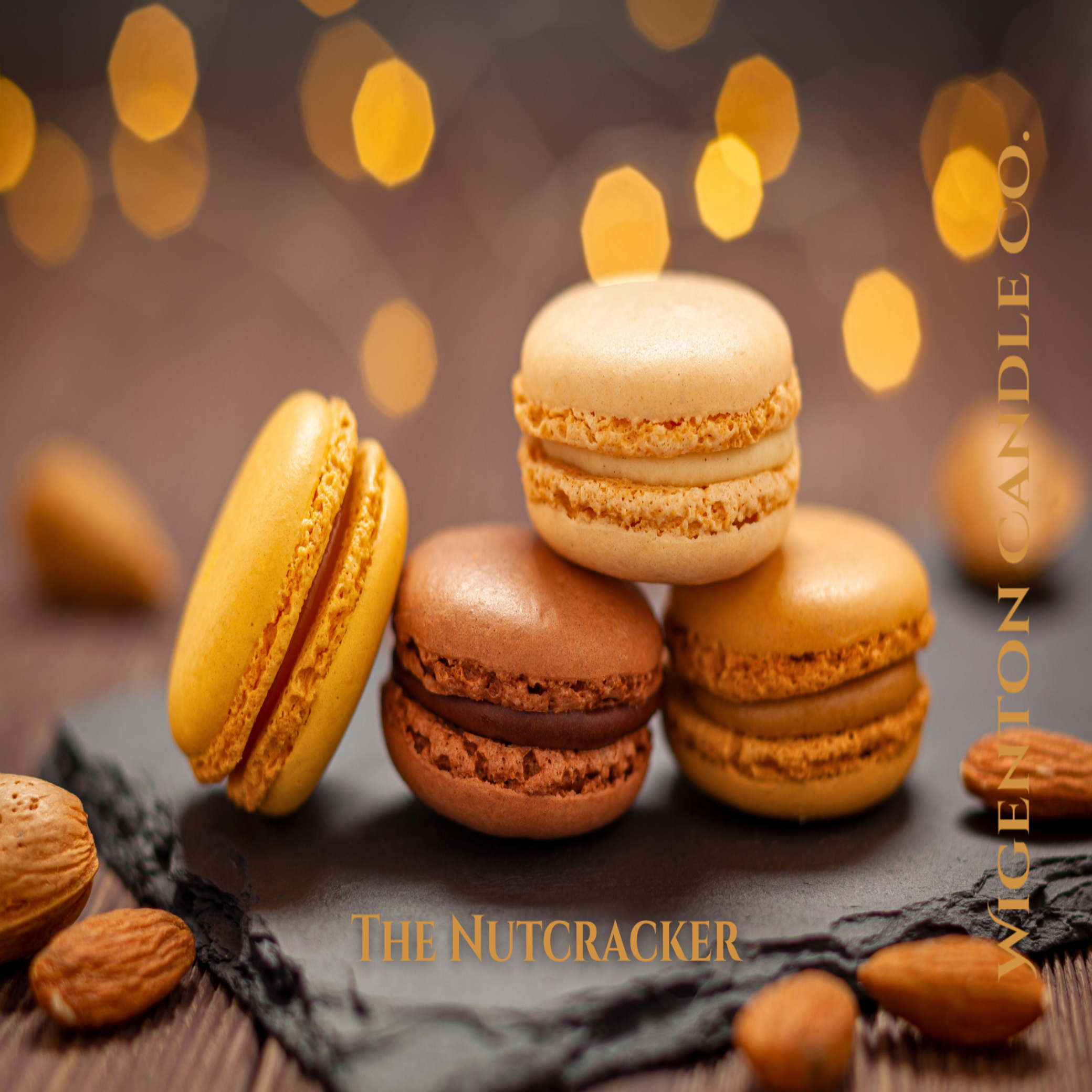 Macarons in yellow, brown, and beige on a dark surface with blurred lights in the background. This is a fragrance by Wigenton Candle Co.