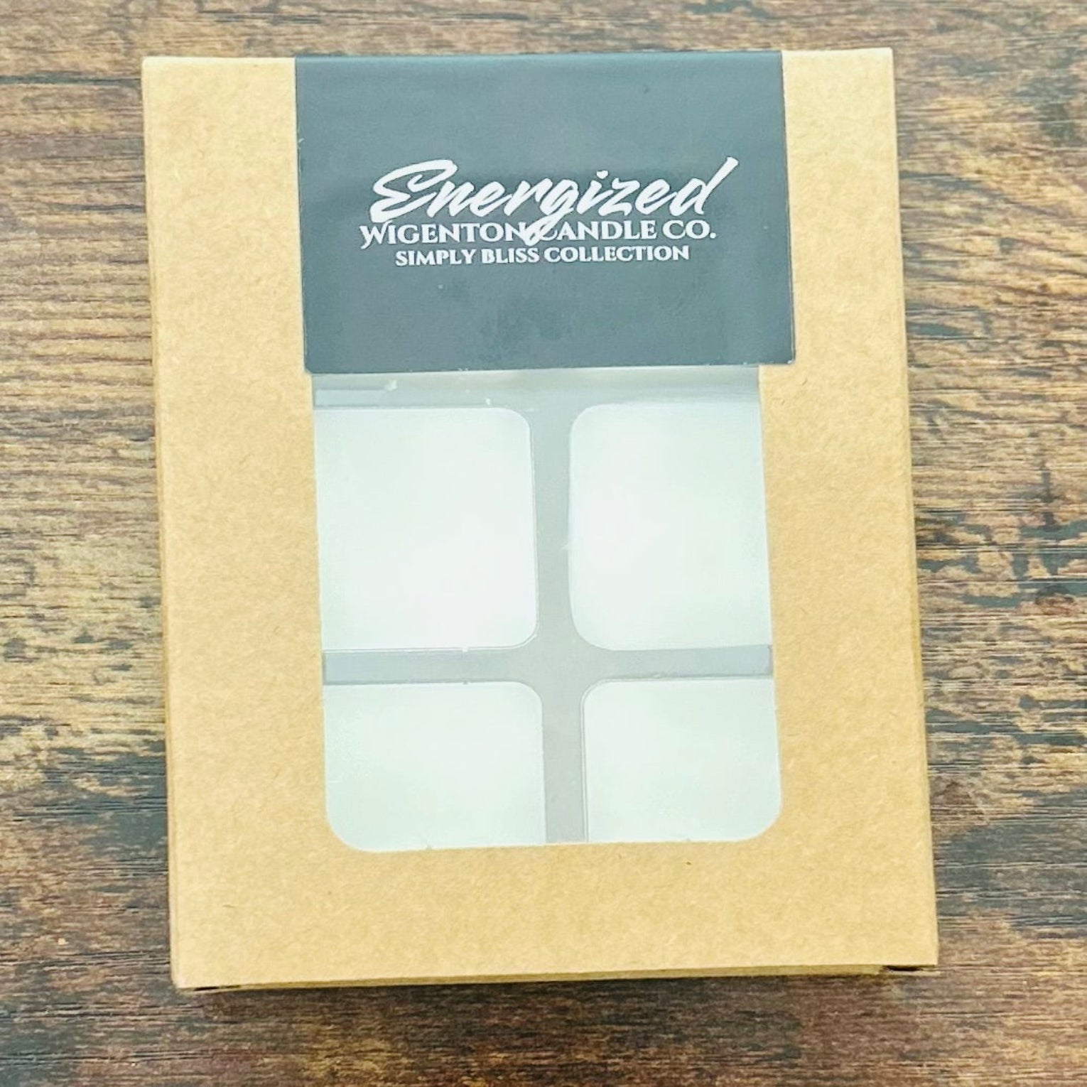 Box of Energized Wigenton Candle Co. melts on a wooden surface