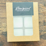 Box of Energized Wigenton Candle Co. melts on a wooden surface