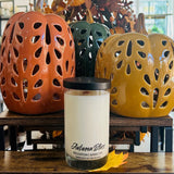 Candle labeled 'Autumn Bliss' with three ceramic pumpkins in the background.