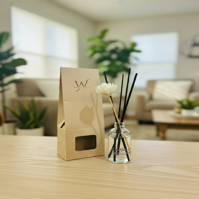 Sleek reed diffuser featuring coconut, sandalwood, and vanilla notes, placed on a clean table in a well-lit workspace or bathroom, designed to evoke calm confidence and polished composure.