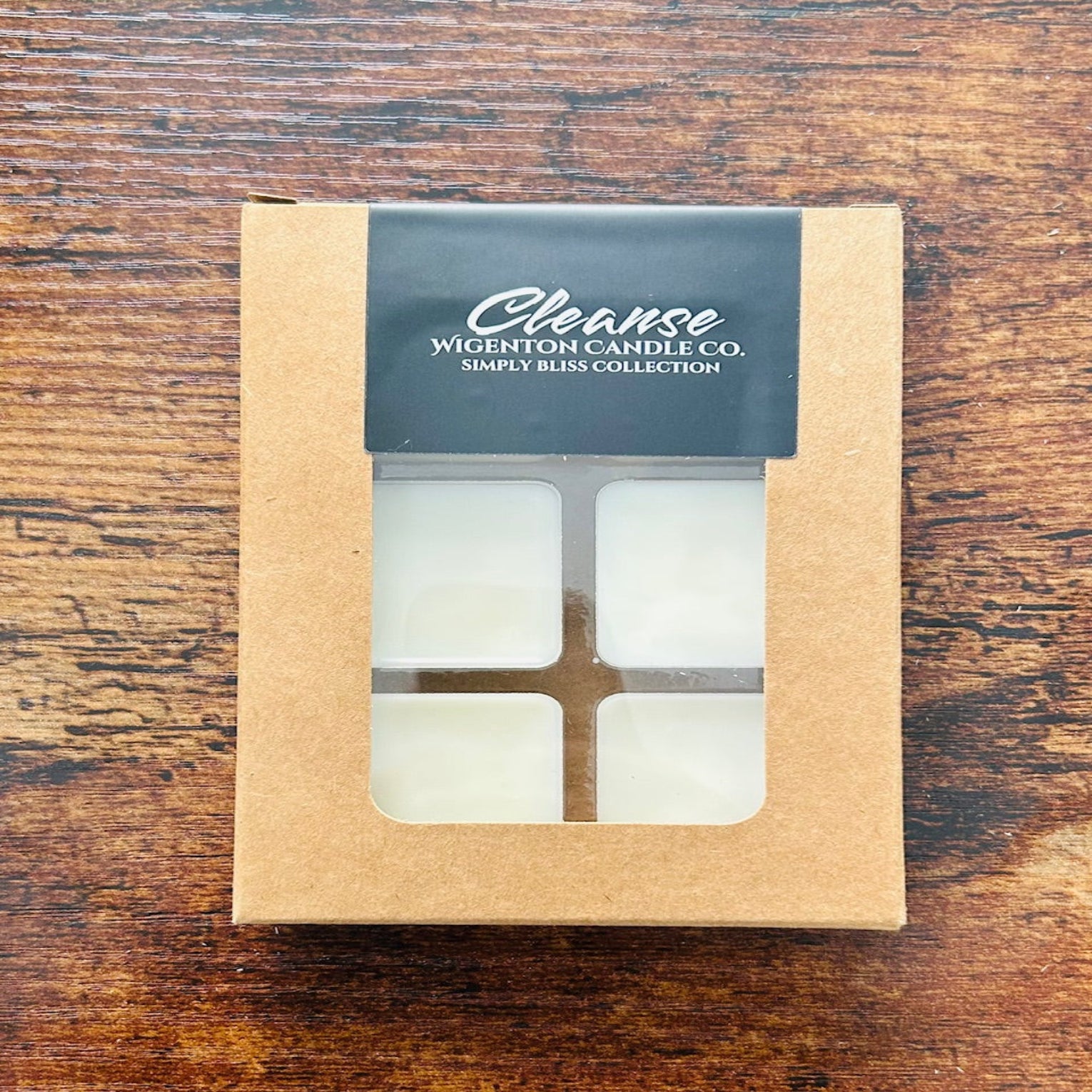 Box of wax melts with a 'Cleanse' label by Wigenton Candle Co. on a wooden surface