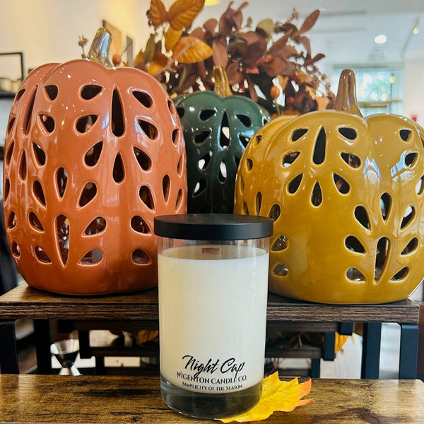 Candle labeled 'Night Cap' with decorative lanterns in the background - Wigenton Candle Co. fragrance. 