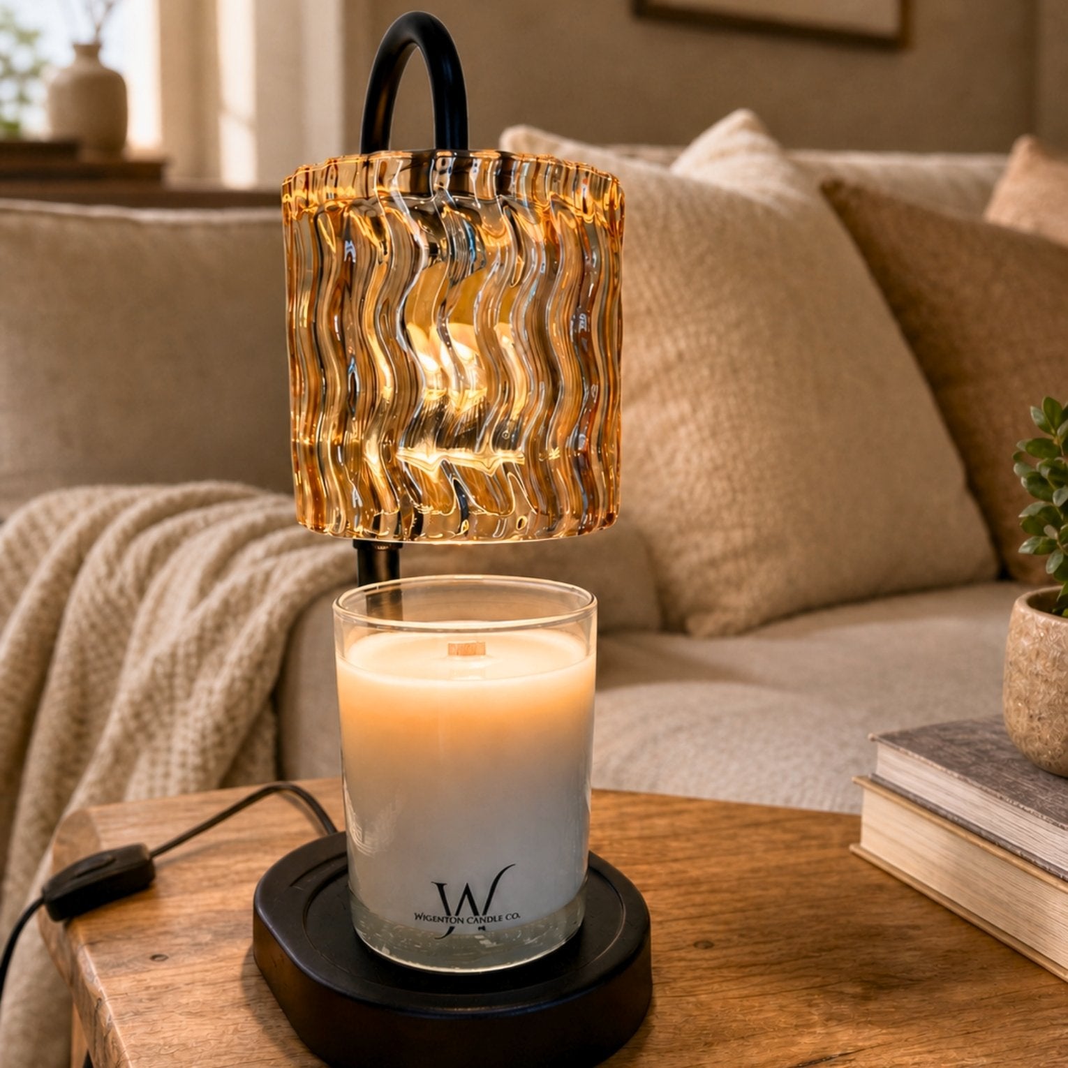 Ripple Glass Candle Warmer Lamp warming a Wigenton Candle Co. candle on a wood table in a cozy neutral living room.