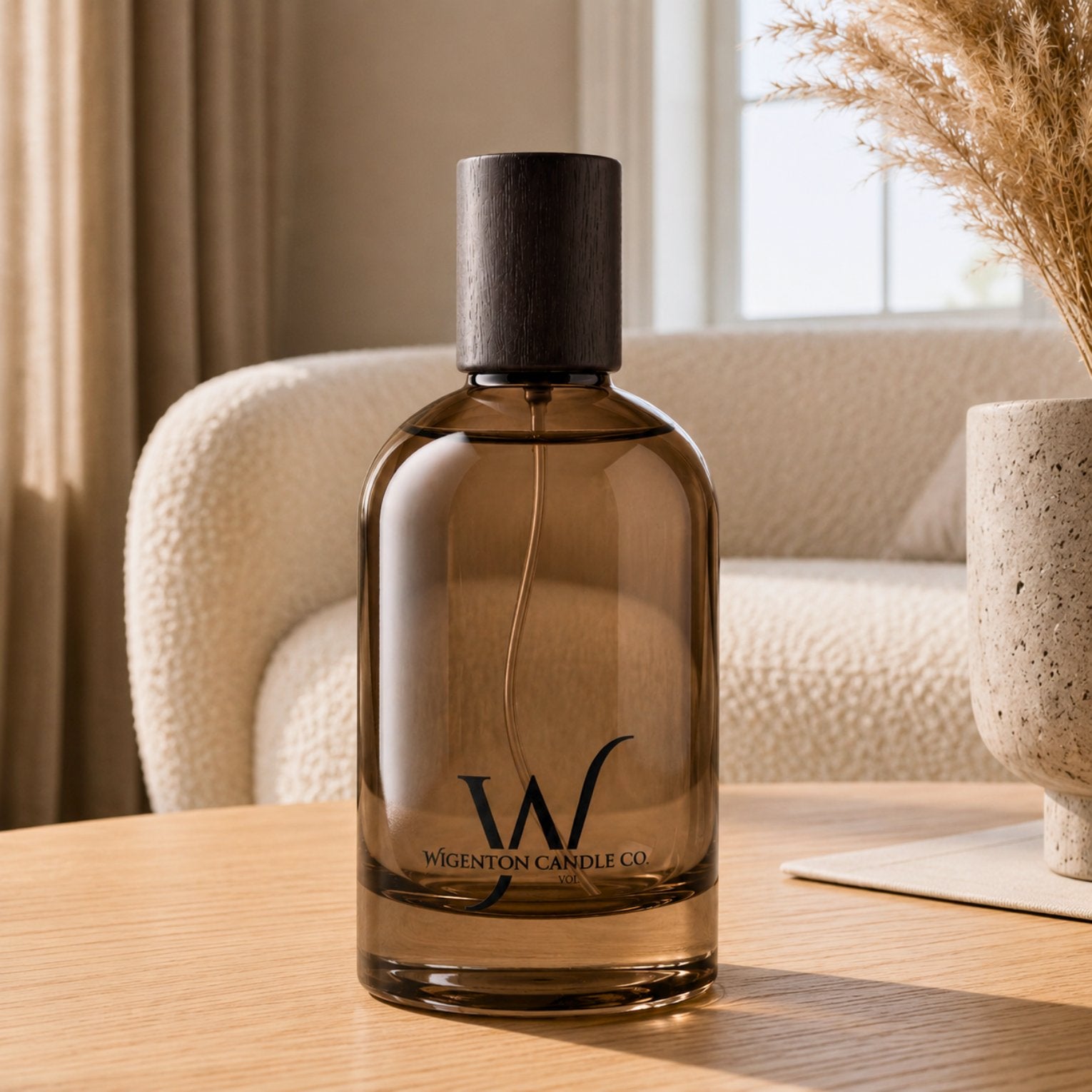 Wigenton Candle Co. fragrance mist in an amber glass bottle styled in a cozy living room to create a clean, inviting atmosphere.