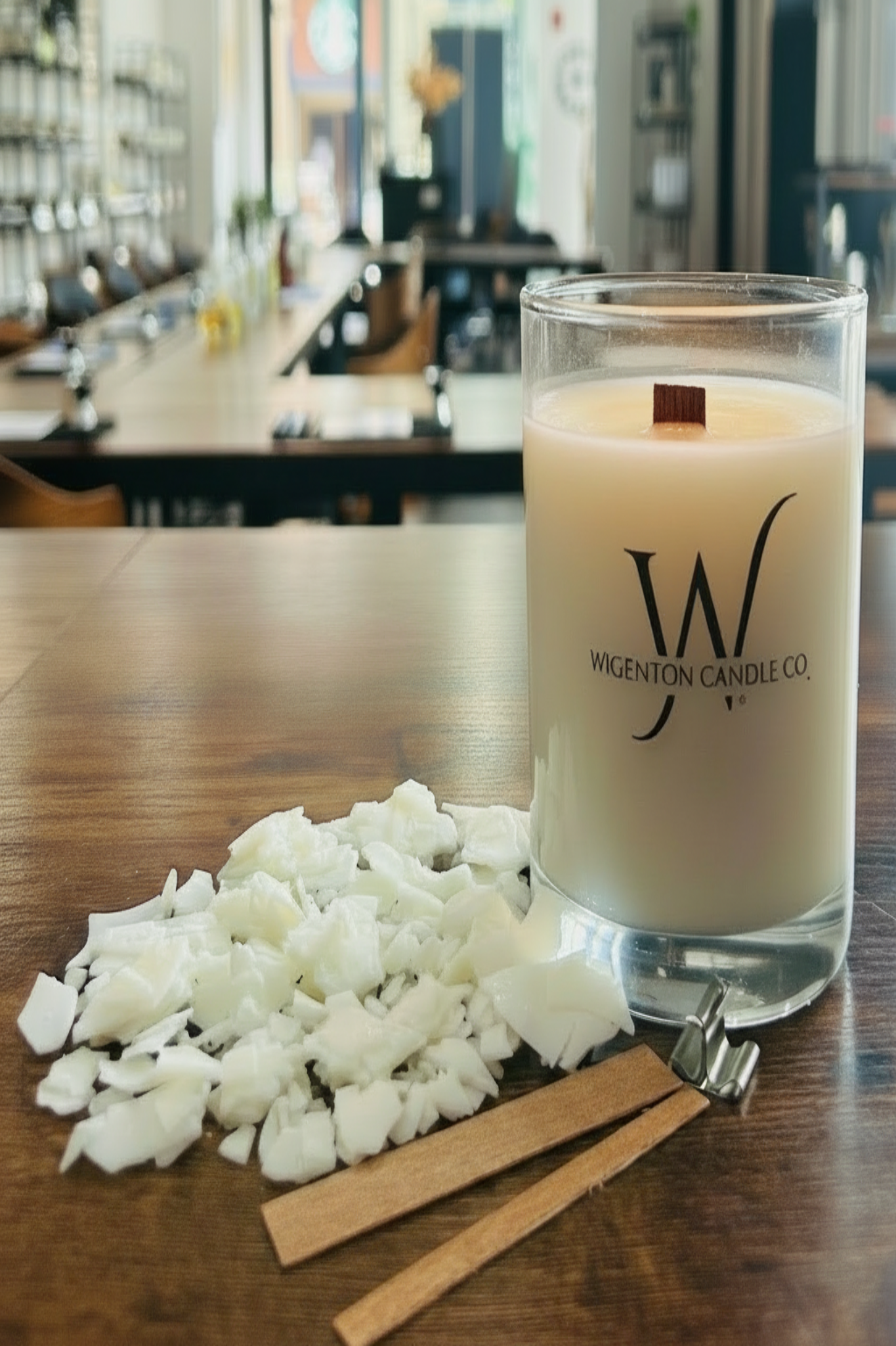 Wigenton Candle Co. candle on a wooden table with decorative elements